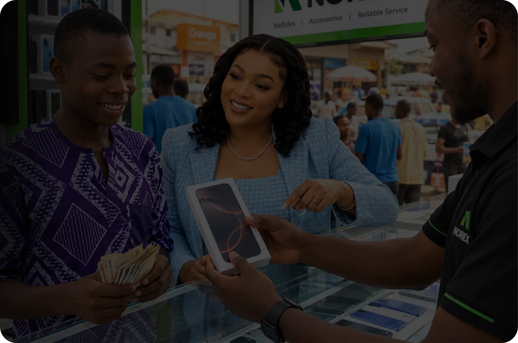 A customer hands over cash for a boxed iPhone at a Norex phone shop counter
